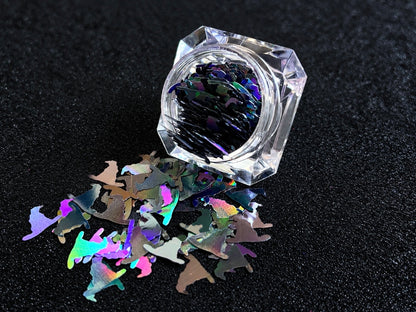 10mm holographic black witch hat glitter shapes spilled from a clear jar onto a black textured background.