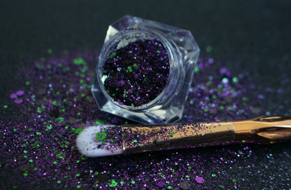 This premium glitter is part of the Halloween glitter collection. It consists of emerald green, dark purple, and black glitter with a metallic sparkle.  Witch's Brew can be used for your face, hair, body, nail art and glitter slime. Available in 5g jars only.