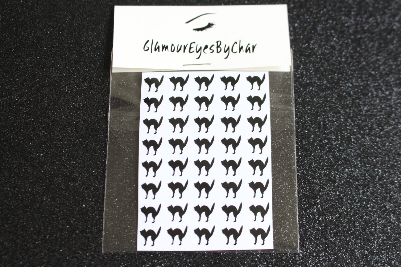 Cat Halloween Nail Stickers – 40 Pieces
Part of our Halloween Collection, these playful cat nail stickers bring just the right mix of spooky and cute to your mani. Apply them to natural or acrylic nails, or layer over polish, gel, or shellac with ease. Handmade with care, they’re also fun for Halloween crafts and DIY projects.

Each pack includes 40 stickers — perfect for hauntingly cute nail art 💅🏾 or spooky DIY fun 🐈.