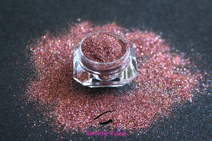  This glitter is part of the simple glitter collection. It consists of holographic rose gold glitter. Cheeky Rose can be used for your face, hair, body, nail art and glitter slime. Available in 5g jars only.  