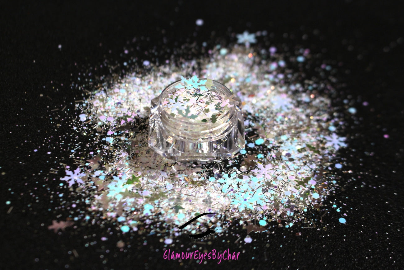 This glitter is called North Pole and is part of the holiday collection.  It consists of  white, silver, light pink, purple, and blue glitter, mixed with iridescent Christmas trees and snowflakes. North Pole can be used for your face, body, hair and nails.  Comes in 5g jars only.  