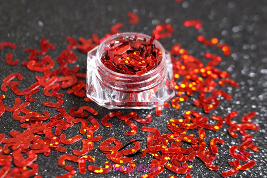 This glitter is called Red Candy Canes and is part of the holiday collection.  It consists of ruby red 7mm candy canes. Red Candy Canes can be used for body and nail art.  Comes in 5g jars only.  