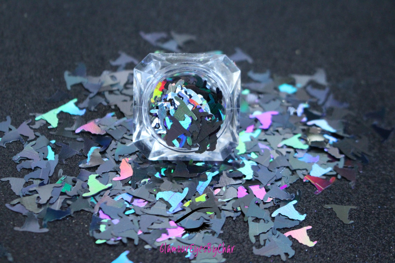 This premium glitter is part of the Halloween collection. It consists of 10mm holographic black witch hats.  Witch Hats  are perfect for body and nail art. Available in 5g jars only.