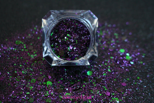 This premium glitter is part of the Halloween glitter collection. It consists of emerald green, dark purple, and black glitter with a metallic sparkle.  Witch's Brew can be used for your face, hair, body, nail art and glitter slime. Available in 5g jars only.