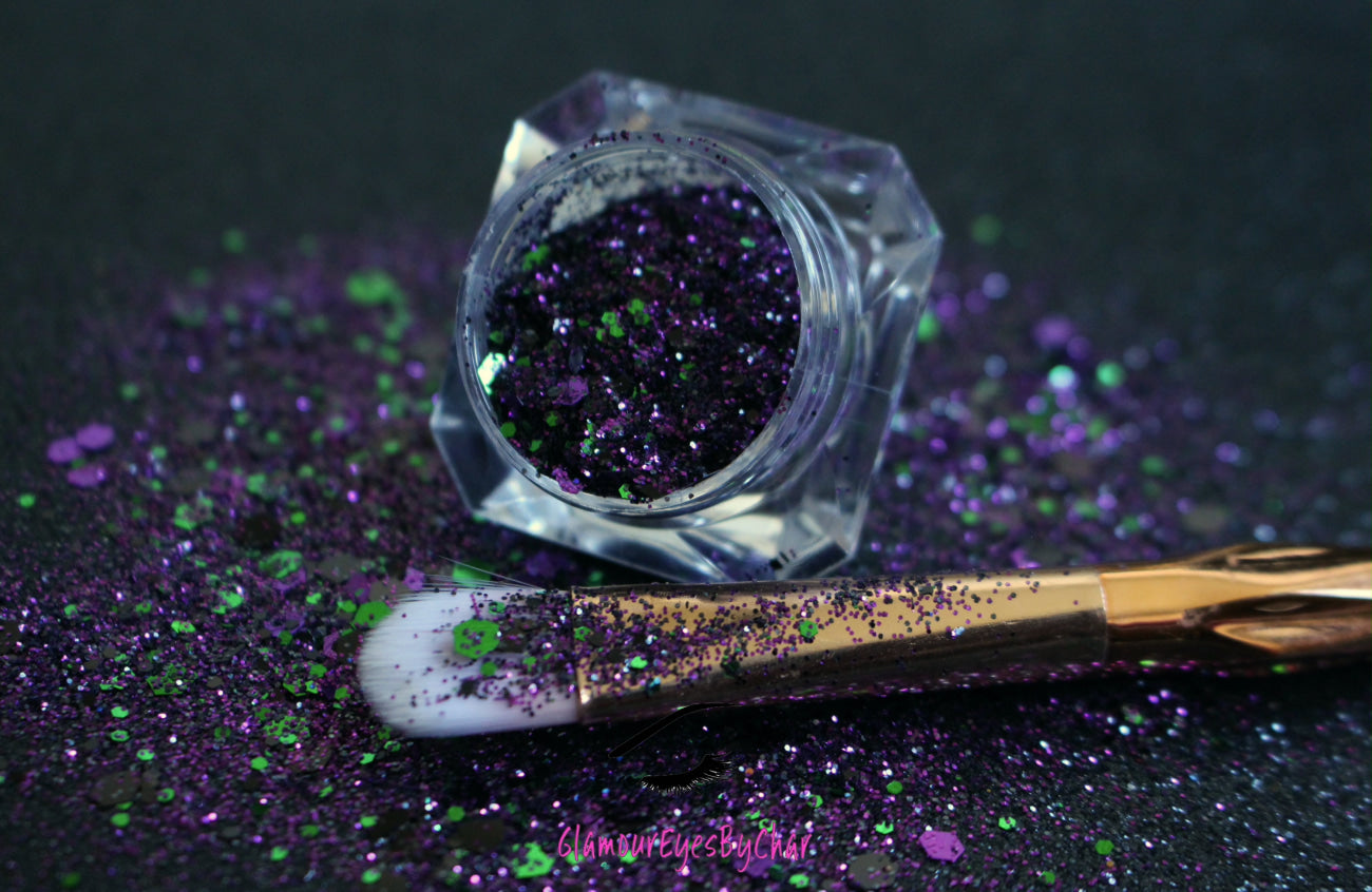 This premium glitter is part of the Halloween glitter collection. It consists of emerald green, dark purple, and black glitter with a metallic sparkle.  Witch's Brew can be used for your face, hair, body, nail art and glitter slime. Available in 5g jars only.