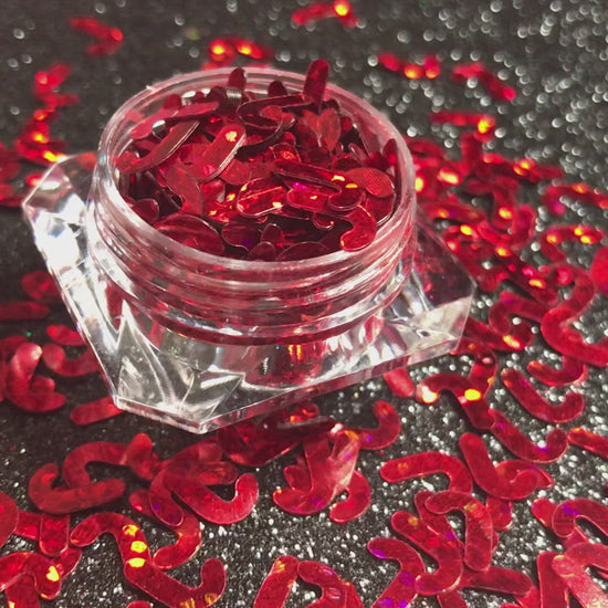 This glitter is called Red Candy Canes and is part of the holiday collection.  It consists of ruby red 7mm candy canes. Red Candy Canes can be used for body and nail art or DIY projects.  Comes in 5g jars only.