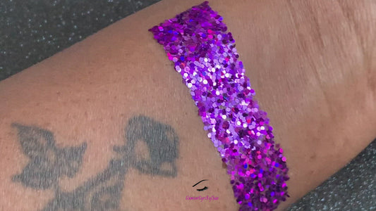 This glitter is called Grapesicle and is part of the simple glitter collection. It consists of dark violet glitter with a holographic sparkle.  Flake size is larger than fine and extra fine glitter.  Grapesicle can be used for your face, body, hair and nails. Comes in 5g jars only.