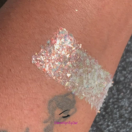 This glitter is called Shimmer and is part of the cellophane glitter flakes collection. It consists of white iridescent glitter shards with golden reflects. Shimmer is perfect for body and nail art, glitter slime, resin art or DIY projects. Comes in 5g jars only.  
