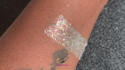 This glitter is called Shimmer and is part of the cellophane glitter flakes collection. It consists of white iridescent glitter shards with golden reflects. Shimmer is perfect for body and nail art, glitter slime, resin art or DIY projects. Comes in 5g jars only.  