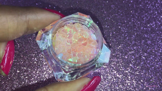 This glitter is called Baby Pink Hearts and is part of the shaped glitters collection. It consists of baby pink hearts with an iridescent sparkle. Baby Pink Hearts is perfect for  body and nail art or DIY projects.  Comes in 5g jars only.