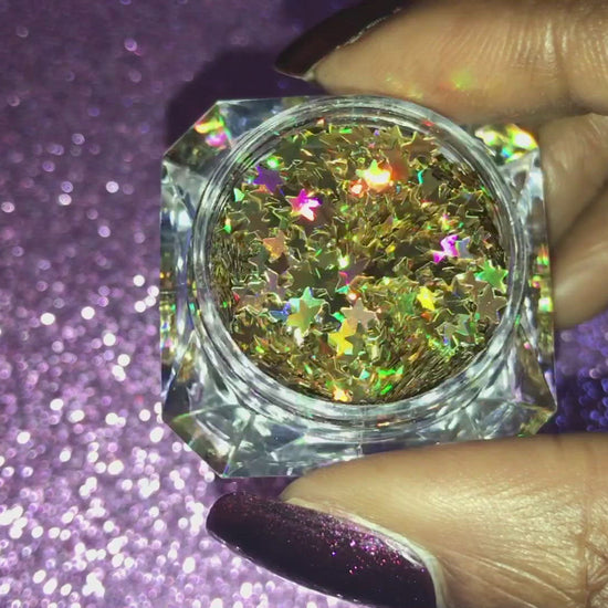 This glitter is called Holographic Gold Stars and is part of the shaped glitters collection.  It consists of gold small stars with a holographic sparkle. Holographic Gold Stars is perfect for body and nail art or DIY projects.  Comes in 5g jars only.