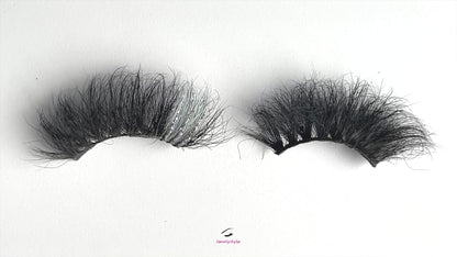 These 5D  premium mink lashes are 25mm in length. They are dramatic, fluffy lightweight, and comfortable to wear on the lids. They have a pop of silver glitter and colour to add an extra sparkle to your eyes. The flexible cotton lash band, makes the application process a breeze.  Stormy lashes are suitable for bold eye looks, and you can wear this reusable style up to 25 times if handled with care. They will definitely make your eyes pop, but are not for timid lash wearers. 