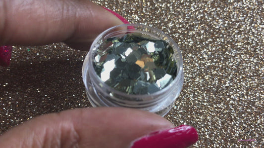 This glitter is called Fool's Gold and is part of the super chunky glitter collection.  It consists of pale gold glitter with a beautiful sparkle. It's perfect for a night out. Fool's Gold can be used for your face, body, hair and nails.  Comes in 5g jars only.