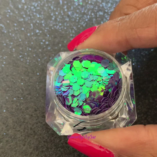This chameleon glitter is called Mesmerize and is part of the super chunky glitter collection. It consists of dark purple glitter with a blue and green unique colour shifting sparkle. Mesmerize can be used for your face, body, hair and nails.  Comes in 5g jars only.