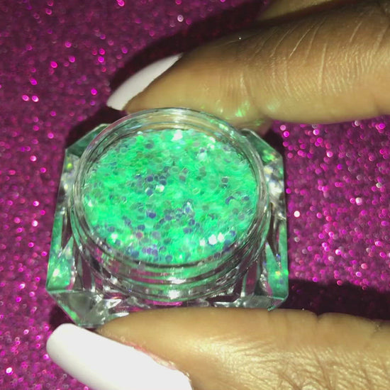 This glitter is called Sea Me and is part of the simple glitter collection. It consists of aqua green glitter with an iridescent sparkle. Flake size is larger than fine and extra fine glitter. Sea Me can be used for your face, body, hair and nails.
