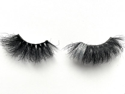 These 5D  premium mink lashes are 25mm in length. They are dramatic, fluffy lightweight, and comfortable to wear on the lids. They have a pop of silver glitter and colour to add an extra sparkle to your eyes. The flexible cotton lash band, makes the application process a breeze.  Stormy lashes are suitable for bold eye looks, and you can wear this reusable style up to 25 times if handled with care. They will definitely make your eyes pop, but are not for timid lash wearers. 