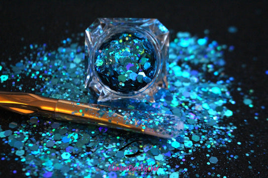 This glitter is called Aquadisiac and is part of the super chunky glitter collection.  It consists of caribbean sea blue glitter with a holographic sparkle.  Aquadisiac can be used for your face, body, hair and nails.  Comes in 5g jars only.  