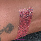This glitter is called Spooky Season and is part of the Halloween glitter collection. It consists of iridescent bright coral with a touch of black holographic glitter. Spooky Season can be used for your face, body, hair and nails.   Comes in 5g jars only. 