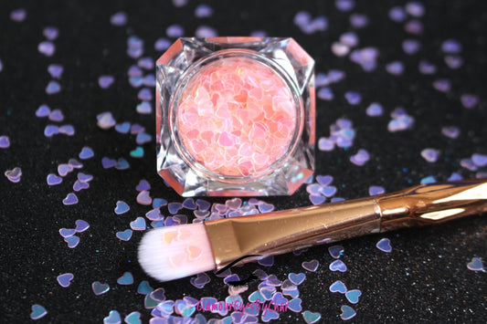 This glitter is called Baby Pink Hearts and is part of the shaped glitters collection. It consists of baby pink hearts with an iridescent sparkle. Baby Pink Hearts is perfect for  body and nail art or DIY projects.  Comes in 5g jars only.