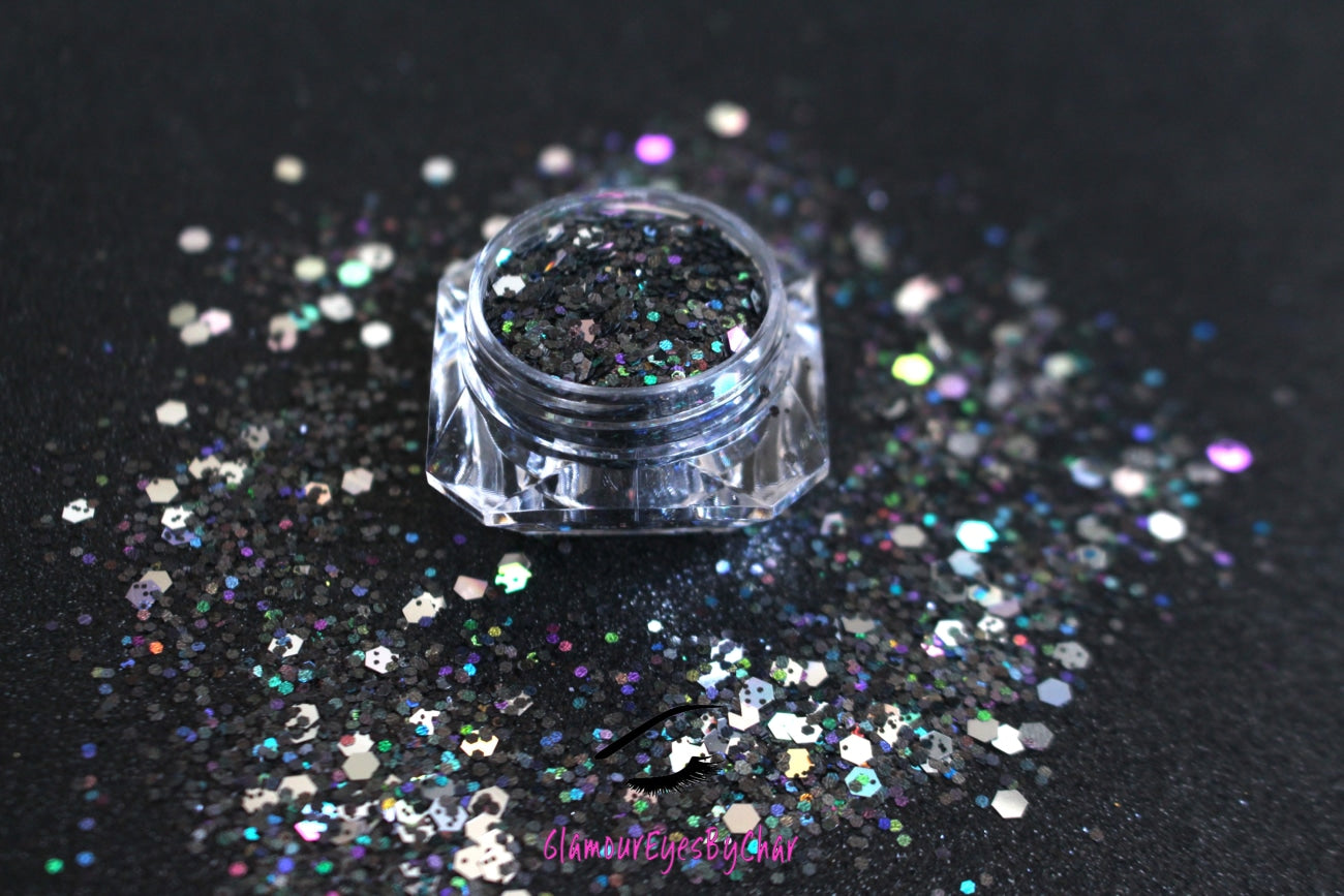 This glitter is called Ball Drop and is part of the super chunky glitter collection. It consists of black and silver holographic glitter with a dazzling sparkle. Ball Drop can be used for your face, body, hair and nails. Comes in 5g jars only. 