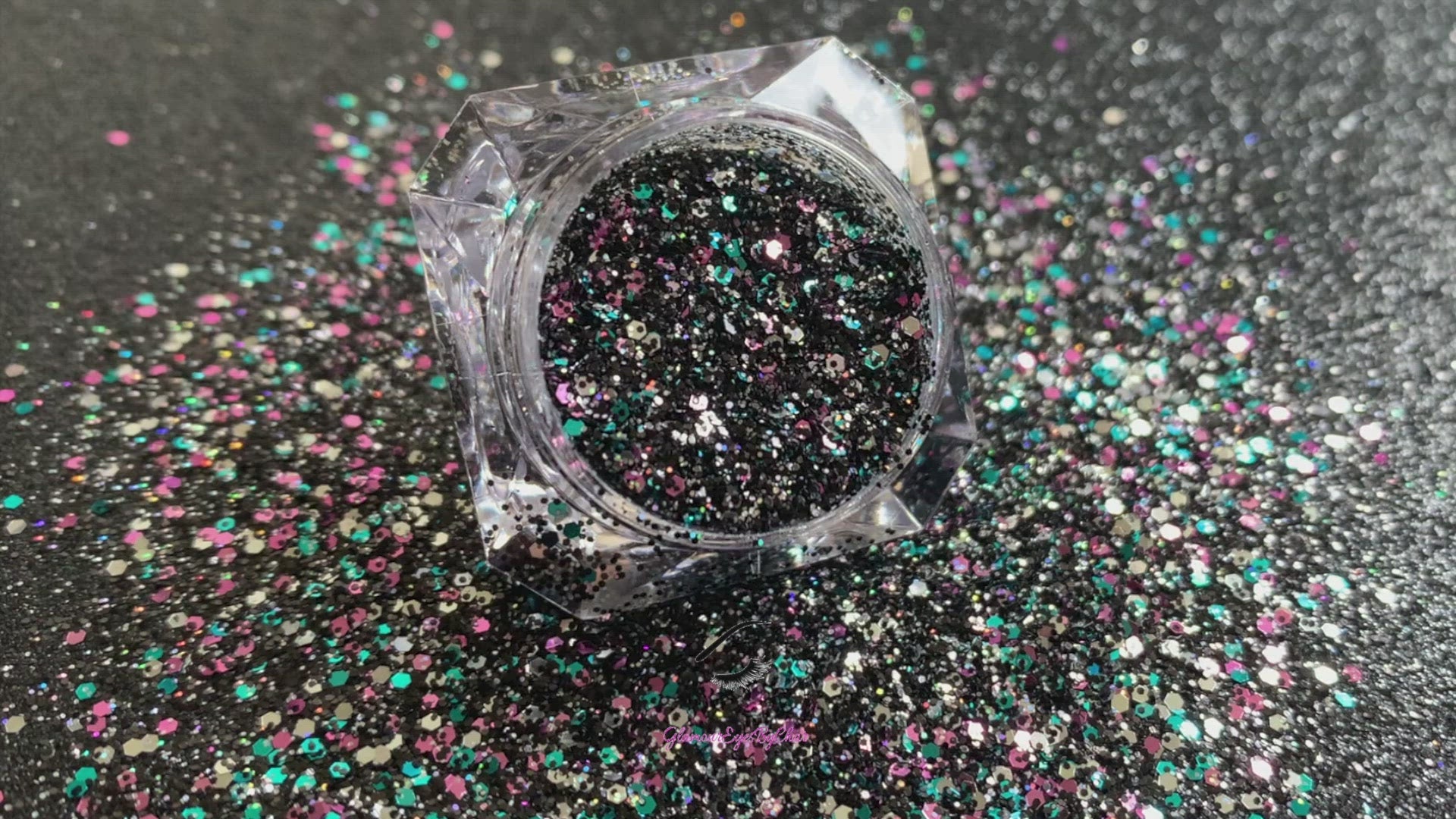 This glitter is called Drama Queen and is part of the chunky glitter collection. It consists of black holographic glitter with a multi-coloured sparkle. Drama Queen can be used for your face, body, hair and nails. Comes in 5g and 10g jars.
