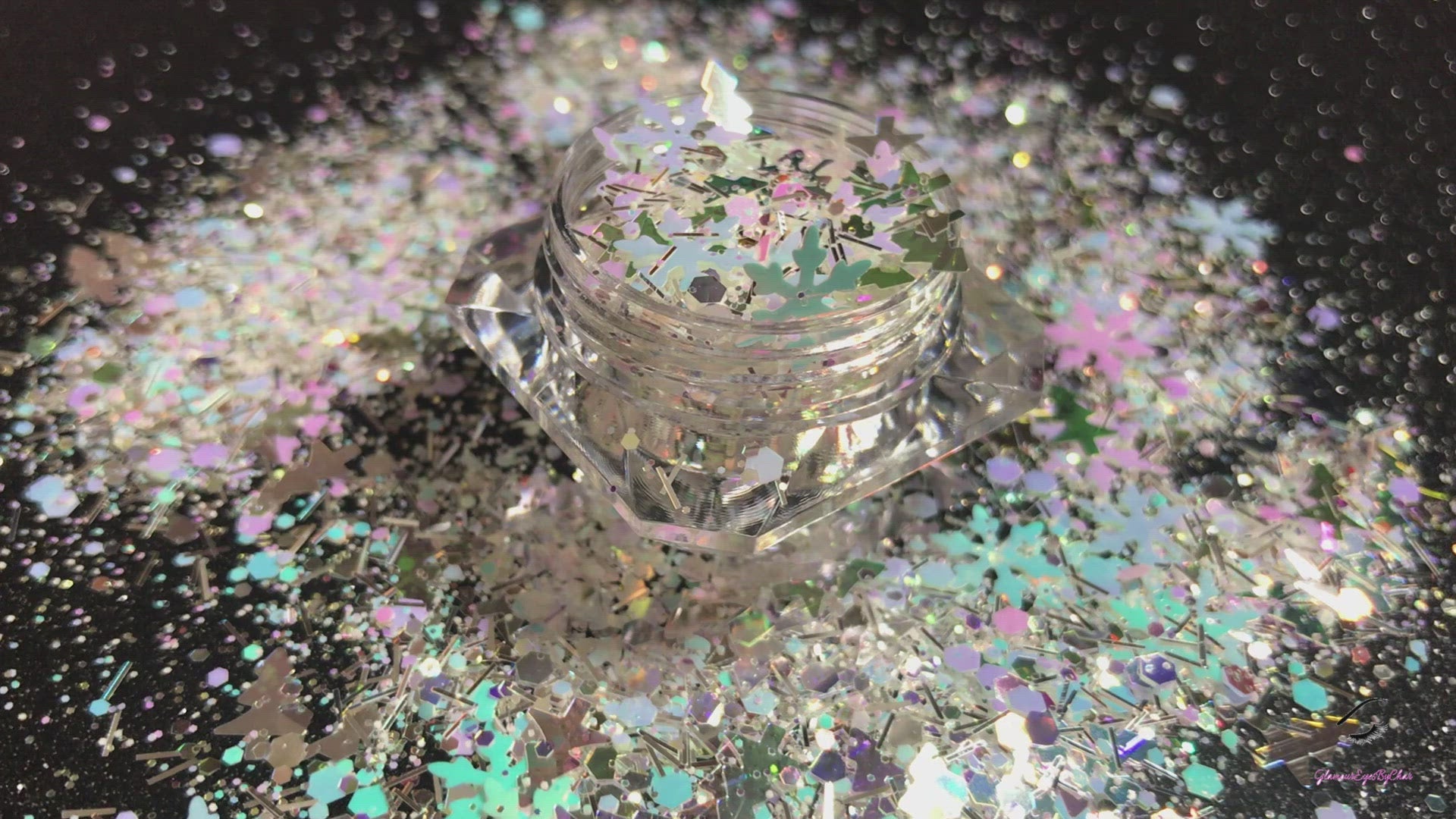 This glitter is called North Pole and is part of the holiday collection. It consists of white, silver, light pink, purple, and blue glitter, mixed with iridescent Christmas trees and snowflakes. North Pole can be used for your face, body, hair and nails. Comes in 5g jars only.