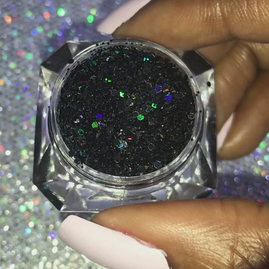 This glitter is called Midnight Madness and is part of the chunky glitter collection. It consists of black glitter with a holographic sparkle. It’s perfect to create a sexy smokey eye look. Midnight Madness can be used for your face, body, hair and nails. Comes in 5g jars only.