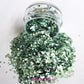 This glitter is called Caicos and is part of the simple glitter collection. It consists of a light teal glitter with a beautiful sparkle. Flake size is larger than fine and extra fine glitter. Caicos can be used for your face, body, hair and nails. Comes in 5g jars only. **Glitter will be discontinued once sold out**