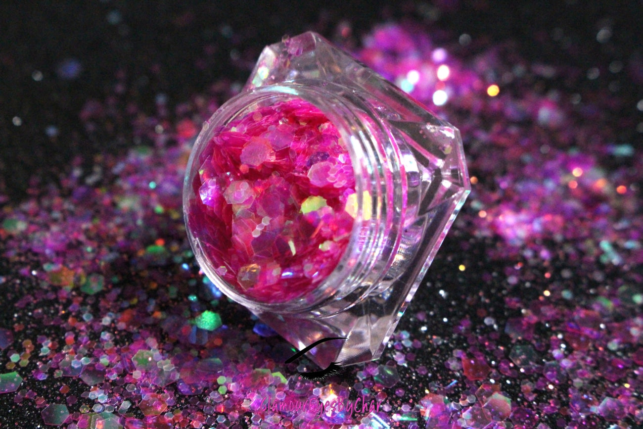 This glitter is called Candy Shop and is part of the super chunky glitter collection.  It consists of fuchsia glitter with an iridescent sparkle. Candy Shop can be used for your face, body, hair and nails.  Comes in 5g jars only.