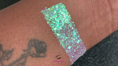 This glitter is called Soft Touch and is part of the cellophane glitter flakes collection. It consists of white iridescent glitter shards with purple and green reflects. Soft Touch is perfect for body and nail art, glitter slime, resin art or DIY projects. Comes in 5g jars only.  