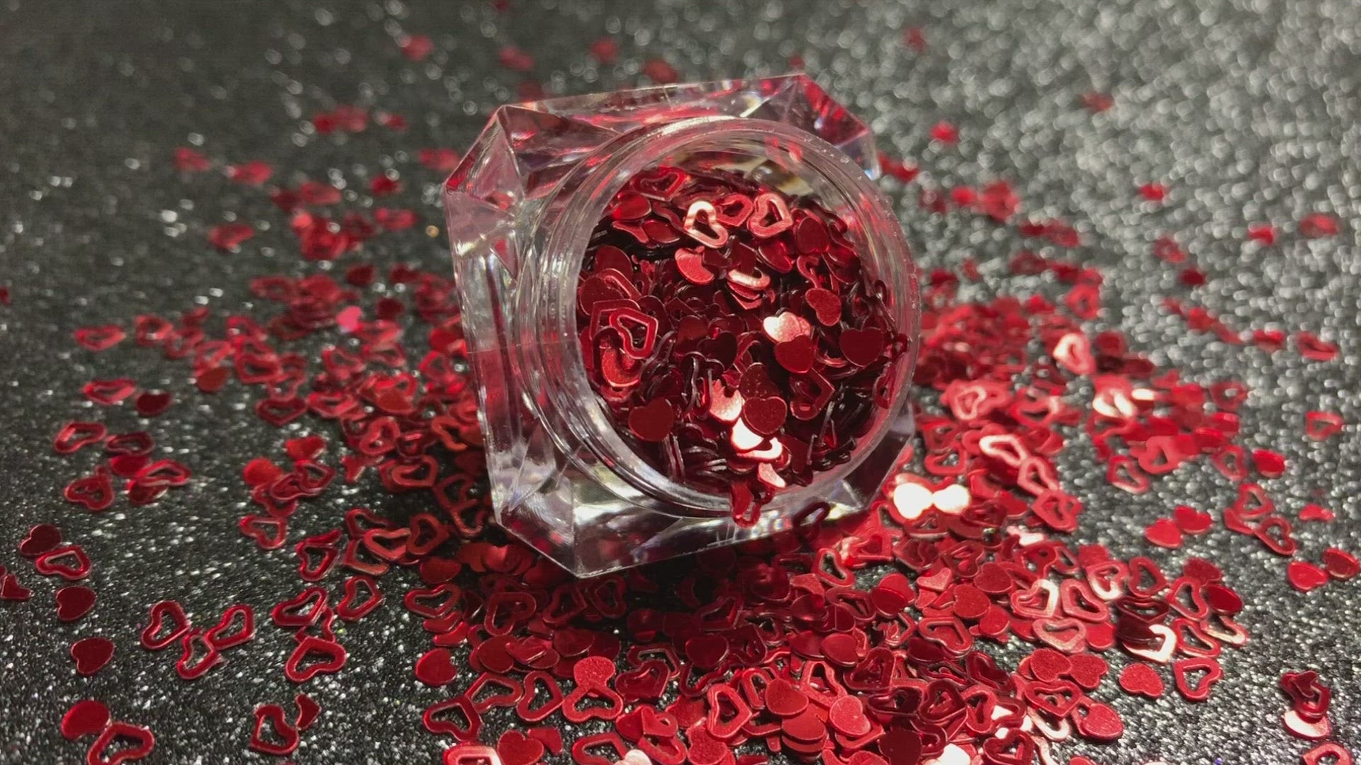 This glitter is called Red Hearts and is part of the shaped glitters collection. It consists of ruby red solid and hollow hearts. Red Hearts can be used for body and nail art or DIY projects. Comes in 5g jars only.