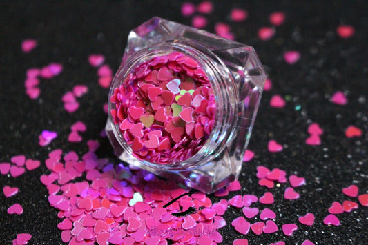 This glitter is called Dark Pink Hearts and is part of the shaped glitters collection. It consists of dark pink hearts with an iridescent sparkle. Dark Pink Hearts is perfect for body and nail art or DIY projects. Comes in 5g jars only.