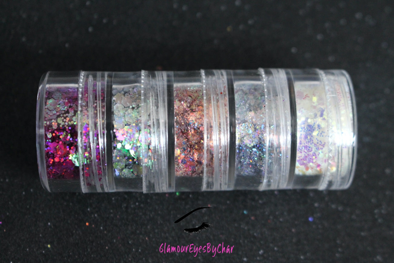 The Dreamland stacker is comprised of dazzling glitters from the super chunky collection. These glitters are perfect for an eye catching look for a night out on the town. The glitters in this set are as follows: Galaxy Illusion She's Perfect Looking Glass Masquerade  The Dreamland stacker can be used for your face, body, hair and nails. Available in 5g jars only. 