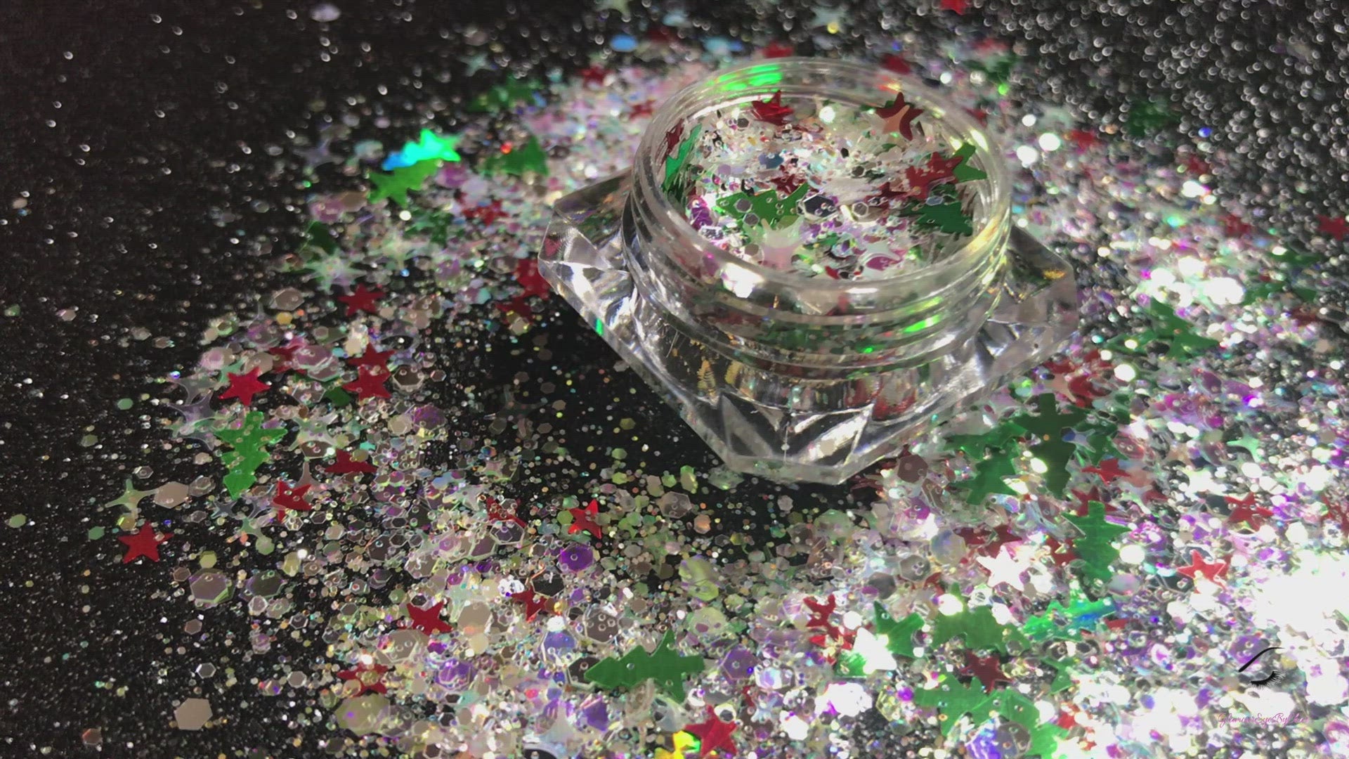 This glitter is called Santa's Grotto and is part of the holiday collection.  It consists of white and silver glitter with green Christmas trees and red stars. Santa's Grotto can be used for body and nail art or DIY projects.  Comes in 5g jars only.