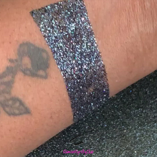 This glitter is called Graveyard Shift and is part of the Halloween glitter collection. It consists of black glitter with a holographic sparkle. Graveyard Shift can be used for your face, body, hair and nails.   Comes in 5g jars only. 