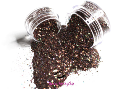 This glitter is called Fondue and is part of the chunky glitter collection. It consists of chocolate brown glitter with an iridescent sparkle. Fondue can be used for your face, body, hair and nails. Comes in 5g and 10g jars.  **Glitter will be discontinued once sold out**