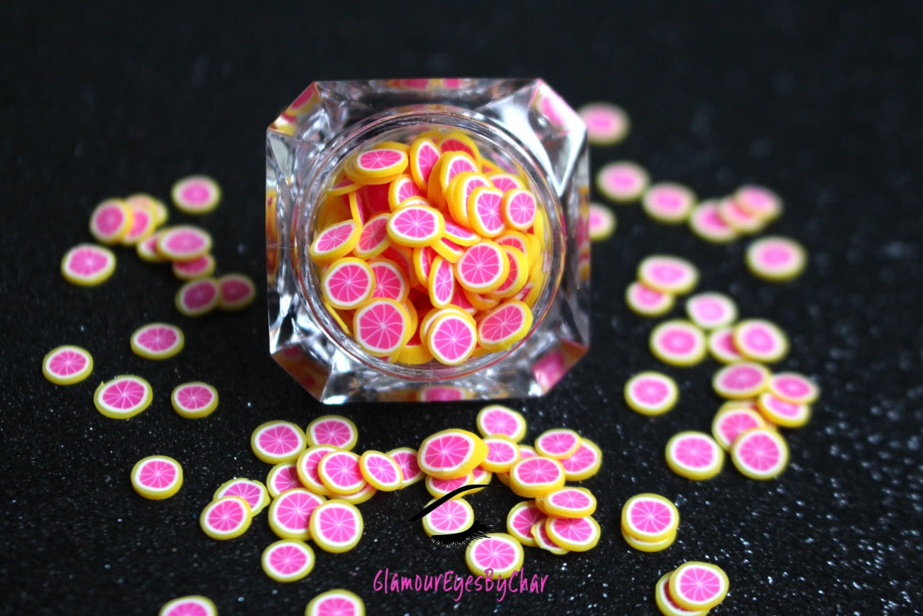 These Grapefruit Fruit Slices are PERFECT for 3D nail or body art. They can also be used for a DIY craft project. The fruit slices are made of polymer clay and are approximately 3mm/0.12 inch in size. Comes in 5g jars only. Note: Grapefruit Fruit Slices are not recommended for use in the immediate eye area. Tip: Apply some of our glitter to your nails to really GLAMOUREYES your look.   