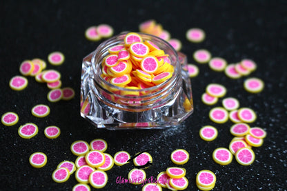 These Grapefruit Fruit Slices are PERFECT for 3D nail or body art. They can also be used for a DIY craft project. The fruit slices are made of polymer clay and are approximately 3mm/0.12 inch in size. Comes in 5g jars only. Note: Grapefruit Fruit Slices are not recommended for use in the immediate eye area. Tip: Apply some of our glitter to your nails to really GLAMOUREYES your look.   