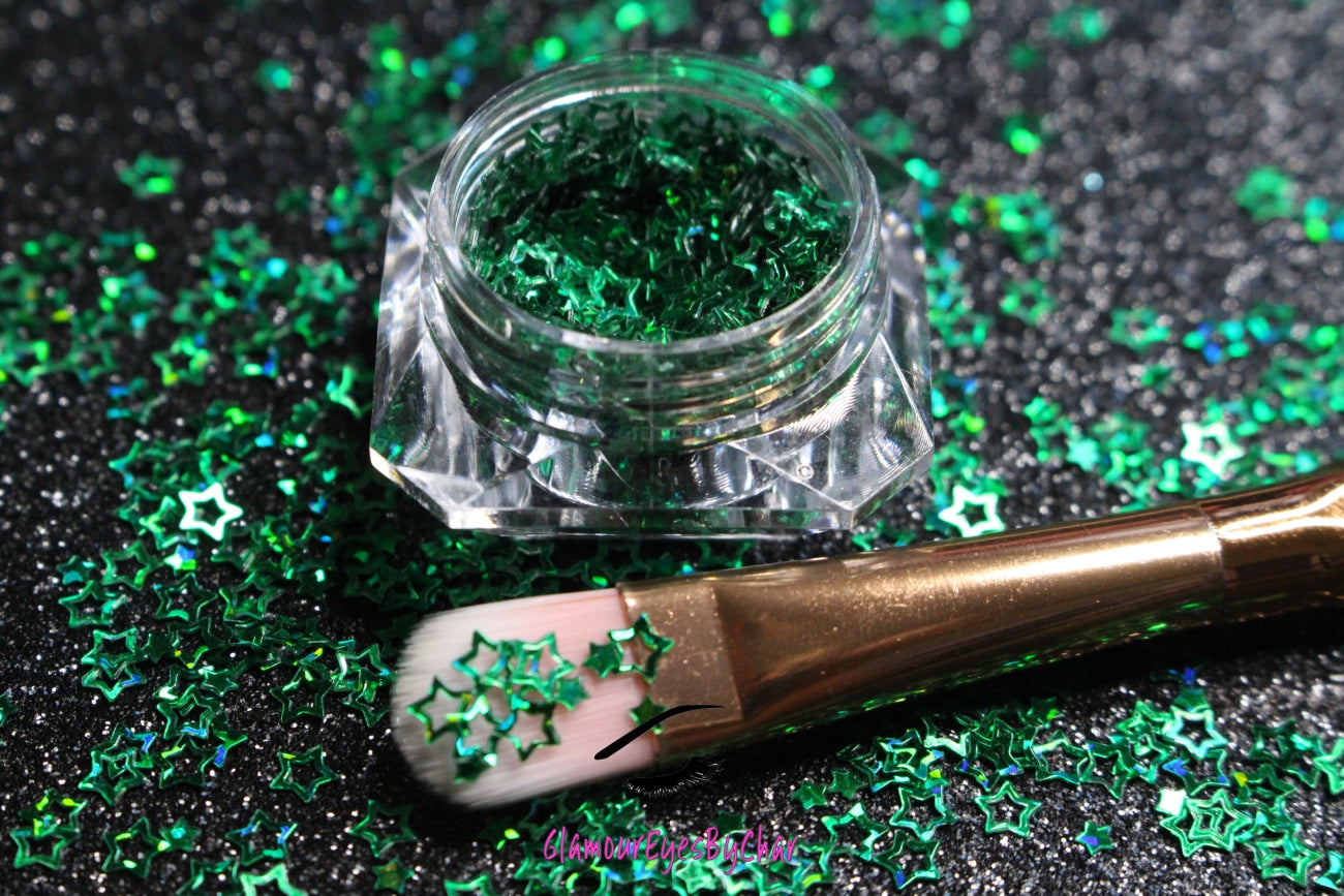 This glitter is called Green Stars and is part of the shaped glitters collection. It consists of emerald green small and large stars. Green Stars is perfect for nail and body art.