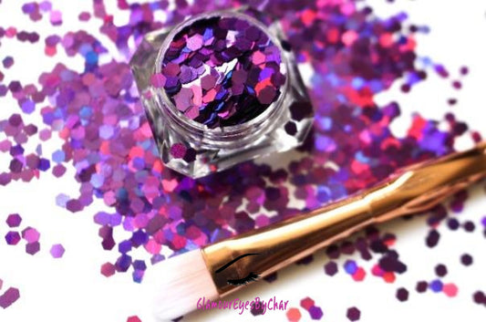This glitter is called Her Majesty and is part of the simple glitter collection. It consists of dark violet glitter with a holographic sparkle. Flake size is 3mm hex. Her Majesty can be used for your face, body, hair and nails. Comes in 5g jars only. **Glitter will be discontinued once sold out**