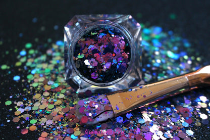 This chameleon glitter is called Hypnotic and is part of the super chunky glitter collection. It consists of dark pink glitter with a purple and teal unique colour shifting sparkle. Hypnotic can be used for your face, body, hair and nails.  Comes in 5g jars only.