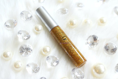 I Said Yes is a clear hydrating gloss with extra fine gold holographic glitter. This gloss is also vegan, gluten-free, high shine, smooth and long lasting. It's made with premium rich ingredients to keep your lips soft, moisturized and luscious without feeling sticky. I Said Yes is available in a squeeze tube and a wand tube (doe foot applicator) for a more precise application.