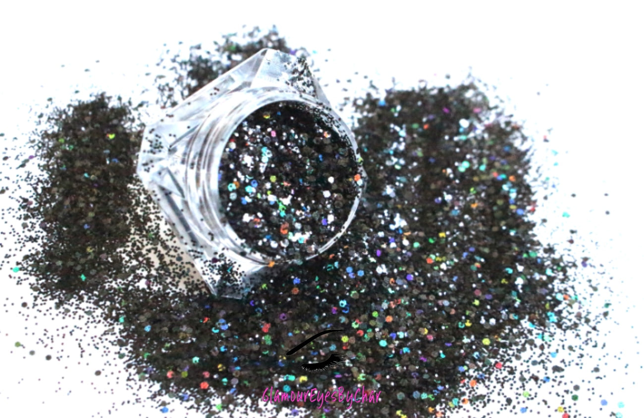 This glitter is called Midnight Madness and is part of the chunky glitter collection. It consists of black glitter with a holographic sparkle. It’s perfect to create a sexy smokey eye look. Midnight Madness can be used for your face, body, hair and nails. Comes in 5g jars only.