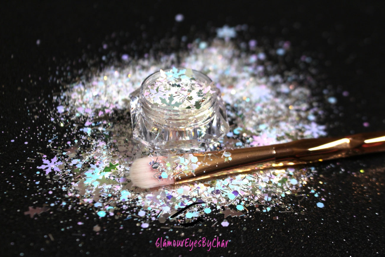 This glitter is called North Pole and is part of the holiday collection.  It consists of  white, silver, light pink, purple, and blue glitter, mixed with iridescent Christmas trees and snowflakes. North Pole can be used for your face, body, hair and nails.  Comes in 5g jars only.  