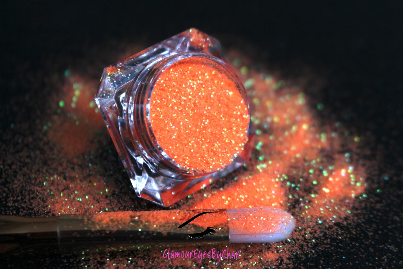 This glitter is called Orange Crush and is part of the simple glitter collection. It consists of vibrant neon orange iridescent glitter that reflects an orange and green sparkle. Orange Crush can be used for your face, body, hair and nails. Comes in 5g jars only.  