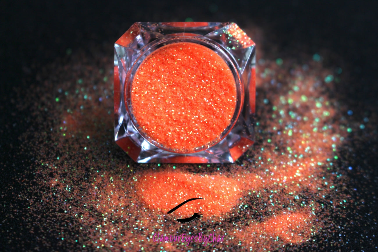 This glitter is called Orange Crush and is part of the simple glitter collection. It consists of vibrant neon orange iridescent glitter that reflects an orange and green sparkle. Orange Crush can be used for your face, body, hair and nails. Comes in 5g jars only.  