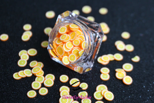 These Orange Fruit Slices are PERFECT for 3D nail or body art. They can also be used for a DIY craft project. The fruit slices are made of polymer clay and are approximately 3mm/0.12 inch in size. Comes in 5g jars only. Note: Orange Fruit Slices are not recommended for use in the immediate eye area. Tip: Apply some of our glitter to your nails to really GLAMOUREYES your look.   