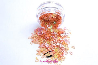 This glitter is called Orange Hearts and is part of the shaped glitters collection. It consists of orange small and large hearts with an iridescent sparkle. Orange Hearts is perfect for body and nail art or DIY projects. Comes in 5g jars only. **Glitter will be discontinued once sold out**