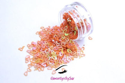 This glitter is called Orange Hearts and is part of the shaped glitters collection. It consists of orange small and large hearts with an iridescent sparkle. Orange Hearts is perfect for body and nail art or DIY projects. Comes in 5g jars only. **Glitter will be discontinued once sold out**