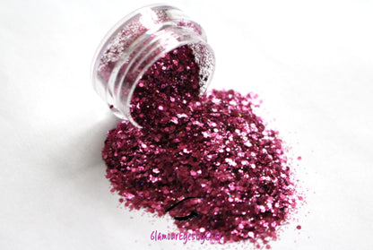 This glitter is called Pinky Swear and is part of the super chunky glitter collection. It consists of magenta glitter with a holographic sparkle.  Pinky Swear can be used for your face, body, hair and nails. Comes in 5g jars only.